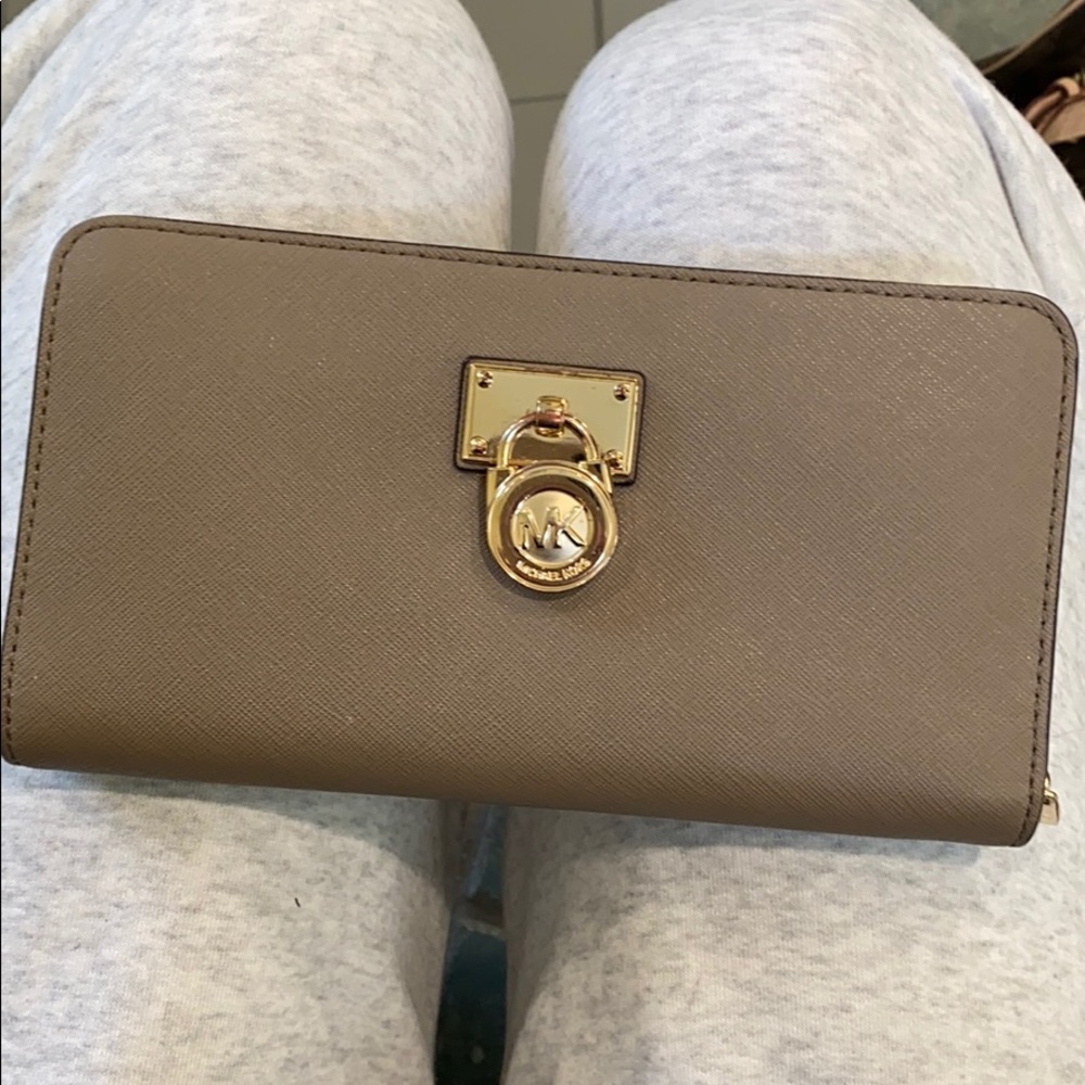 MK wallet with gold lock.
